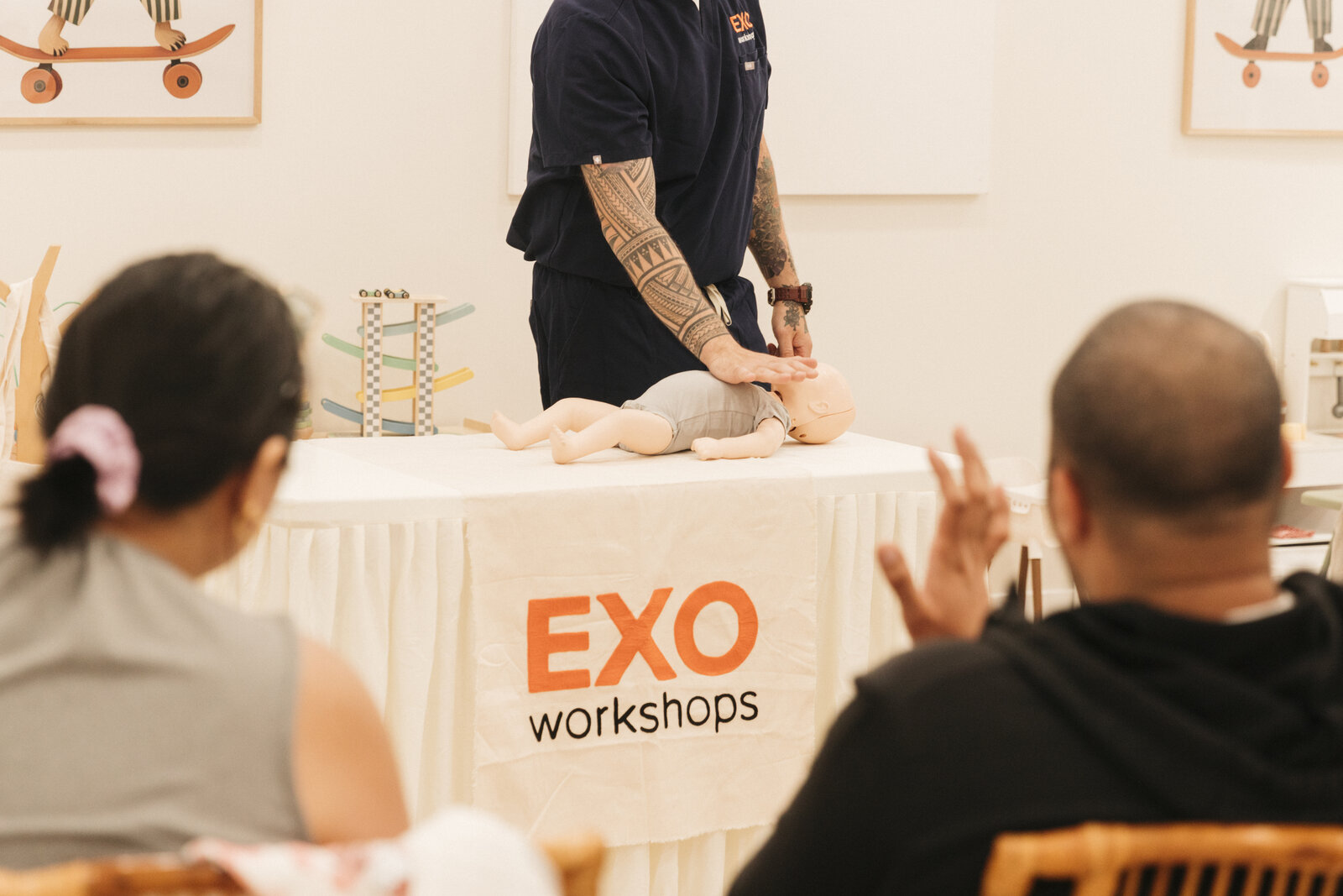 EXO instructor demonstrating infant CPR to workshop participants